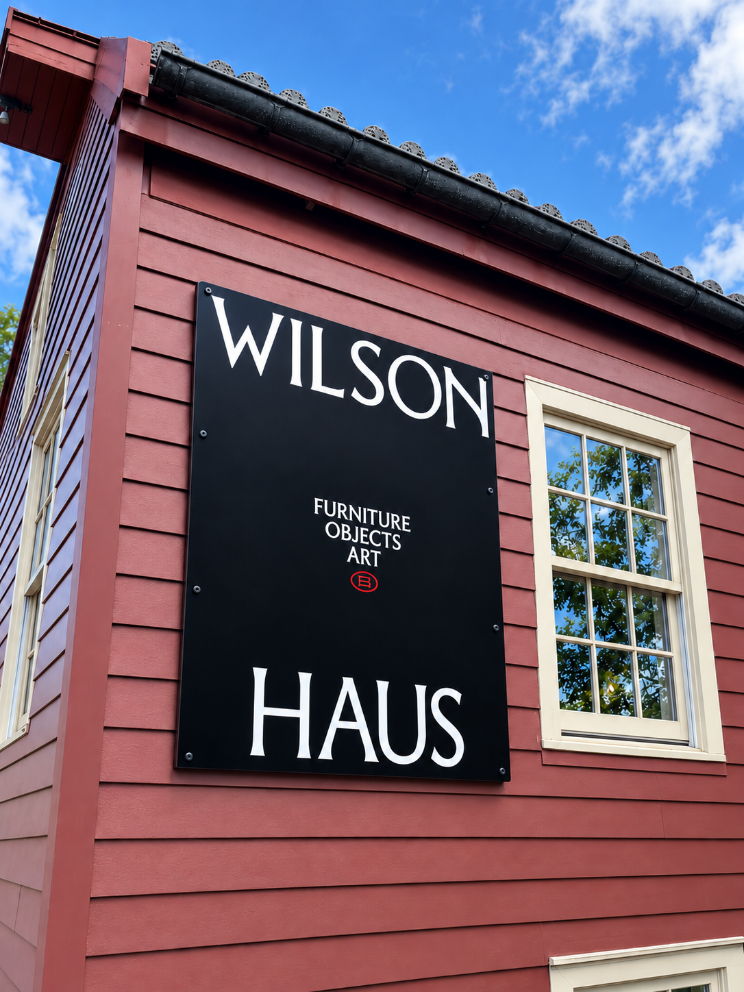Custom black exterior wall sign for Wilson Haus Furniture — designed and crafted by Frenchtown Signs in Frenchtown, NJ