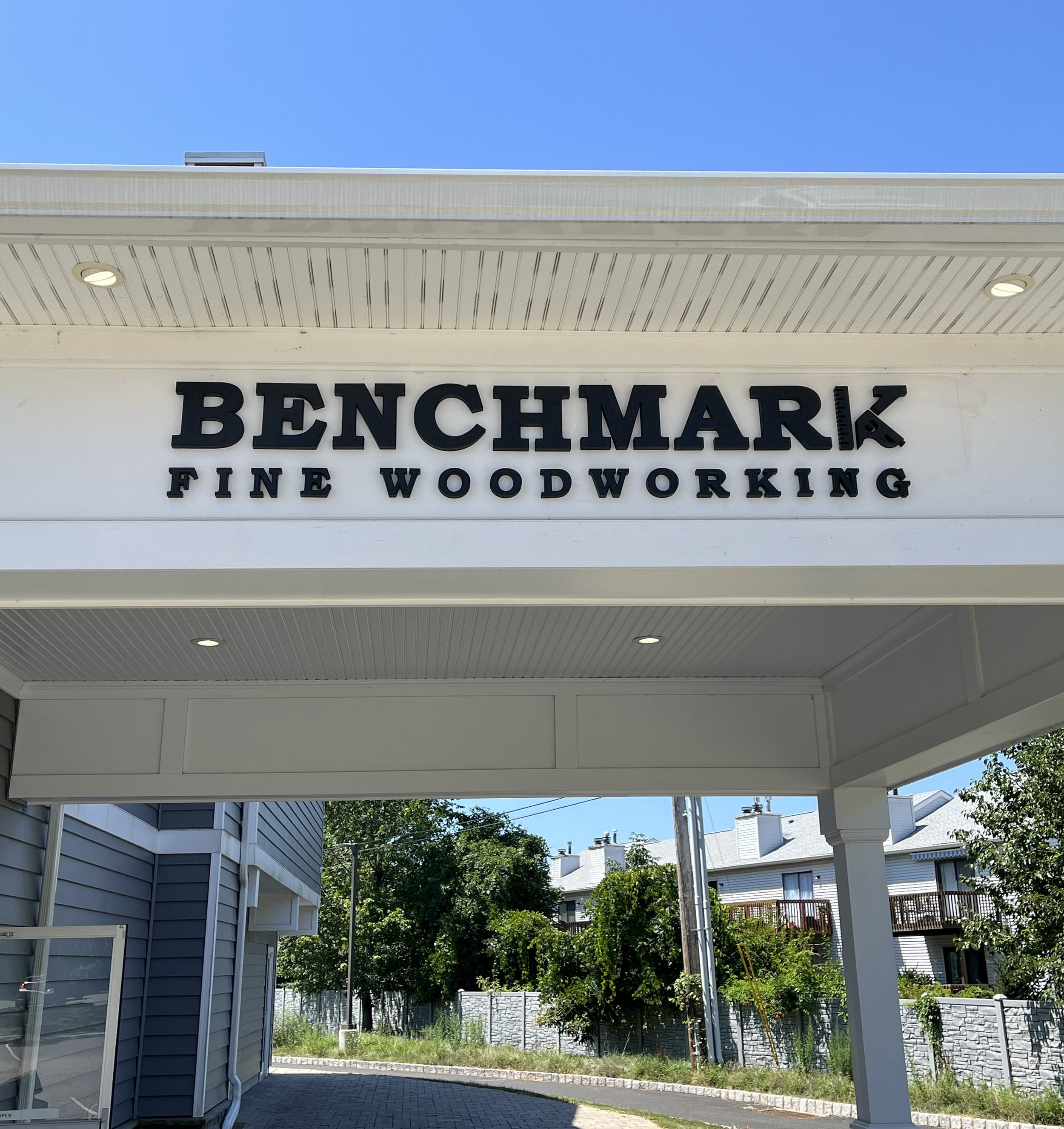 Custom workshop exterior sign for Benchmark Fine Woodworking — designed and crafted by Frenchtown Signs in Frenchtown, NJ