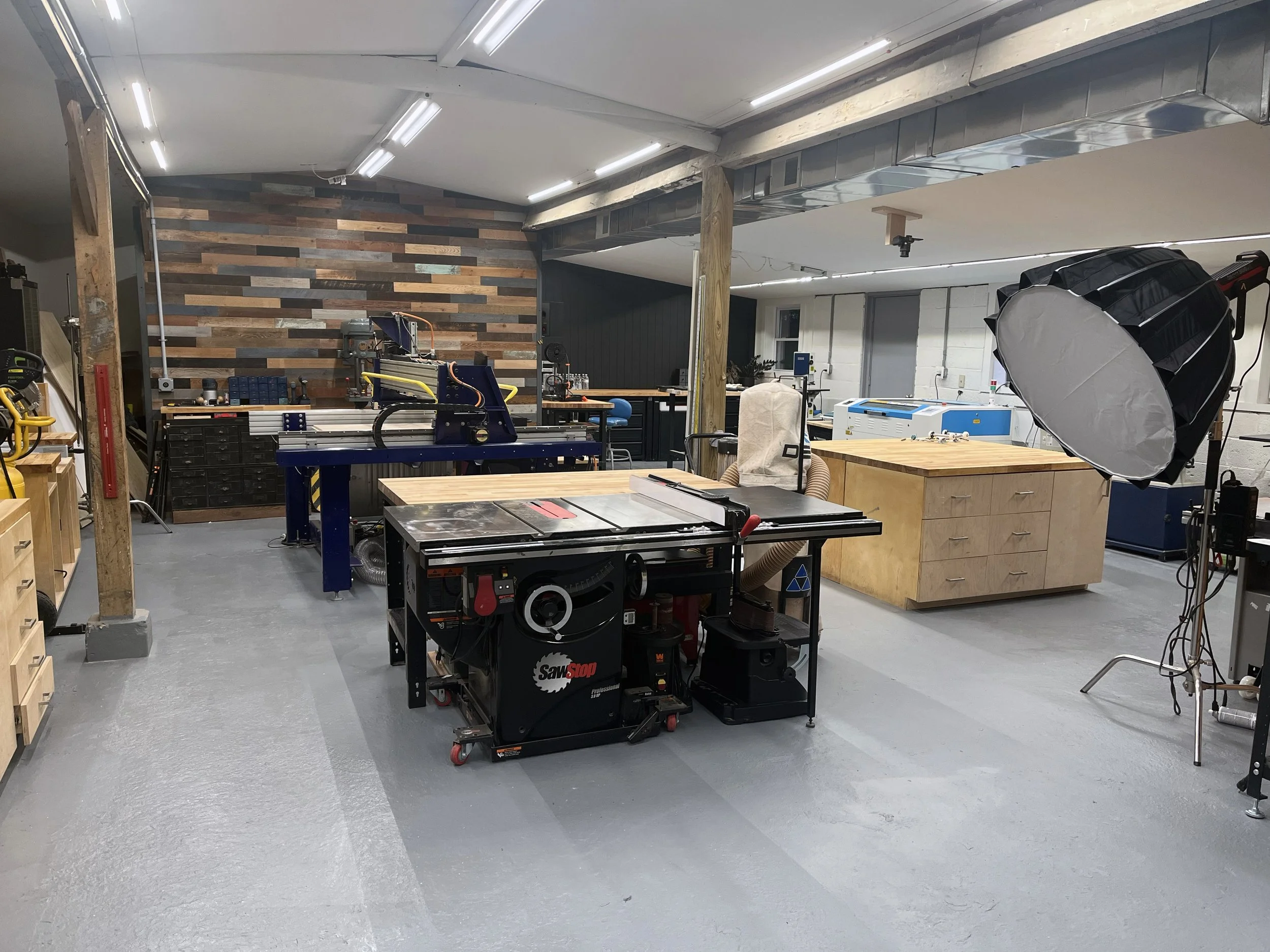 Inside the Frenchtown Signs workshop in Frenchtown, NJ — CNC routers, laser cutters, and woodworking tools used to craft custom signs